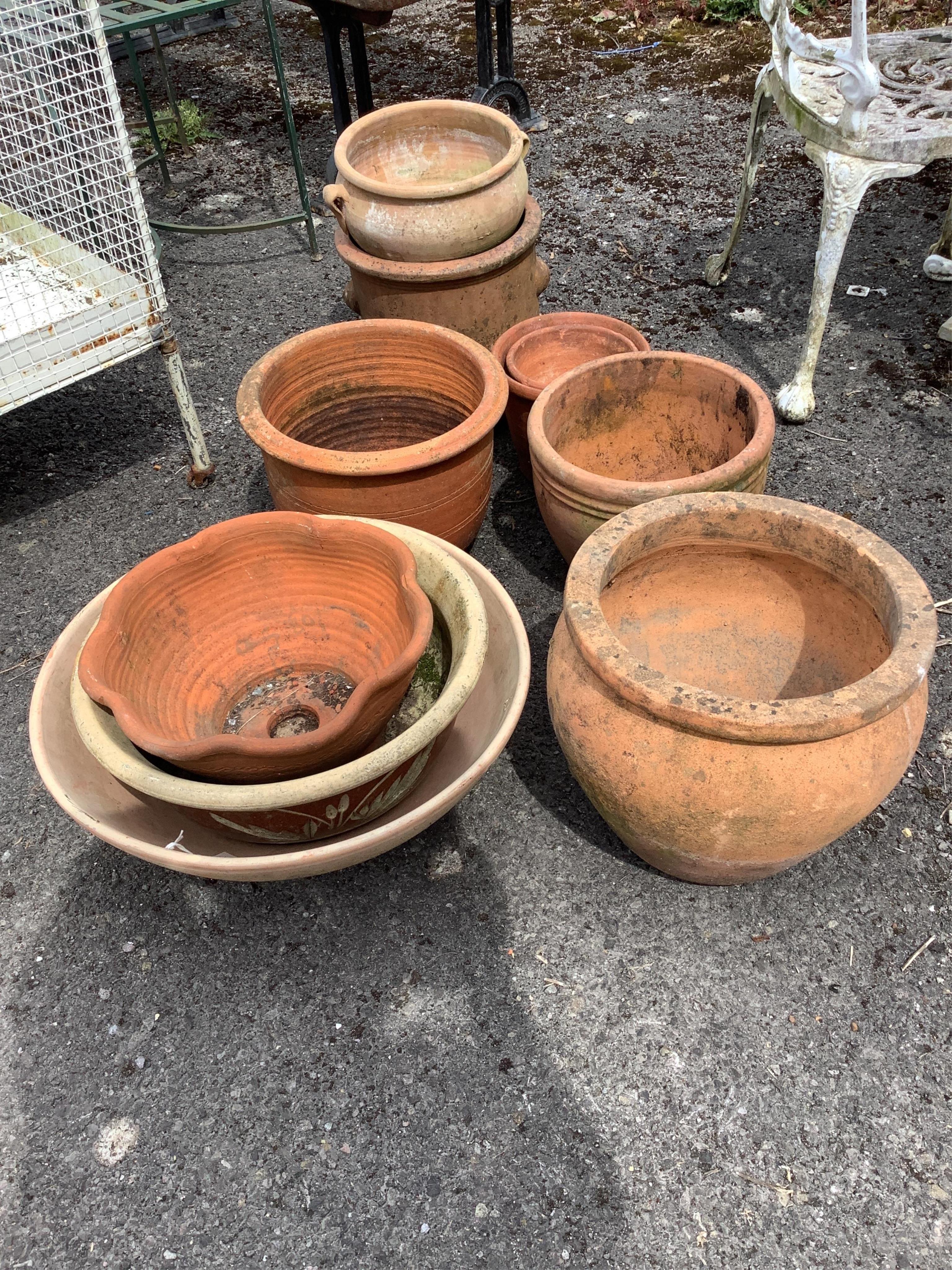Ten assorted terracotta garden planters and three dish stands, largest diameter 32cm, height 30cm
